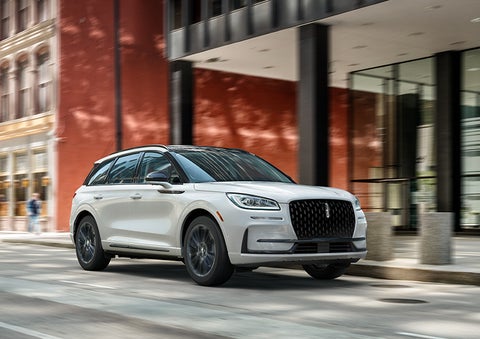 The 2024 Lincoln Corsair® SUV with the Jet Appearance Package and a Pristine White exterior is parked on a city street. | Koons Lincoln of Bethesda in Silver Spring MD