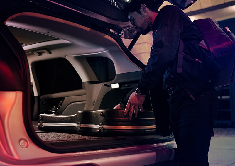 A man is shown loading cargo into the rear of a 2024 Lincoln Corsair® SUV with the second-row seats folded flat. | Koons Lincoln of Bethesda in Silver Spring MD